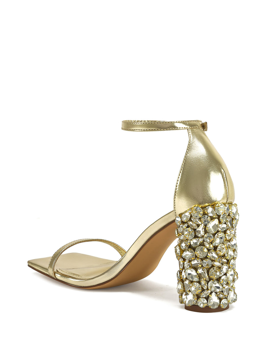 metallic gold open toe heeled sandals with a crystal embellished block heel and an adjustable ankle strap closure