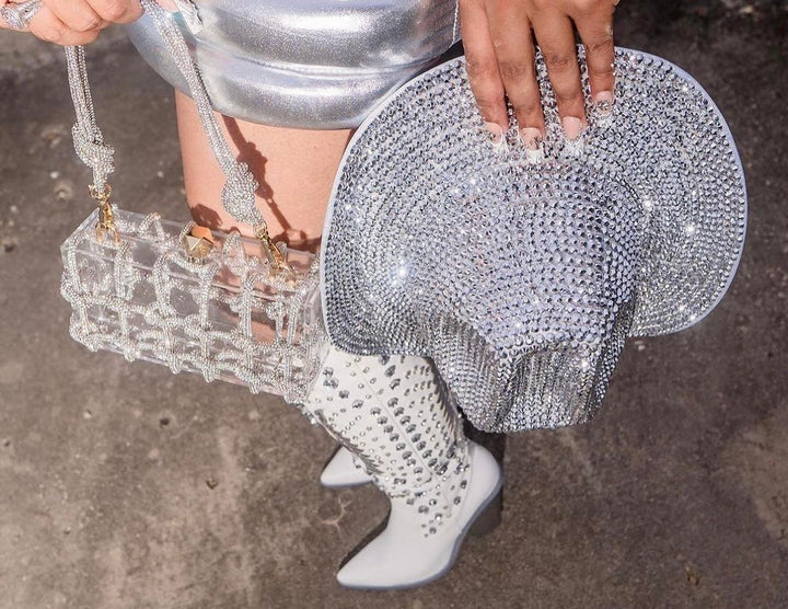 Silver outfit with a reflective cowboy hat, statement shoes, and a statement purse