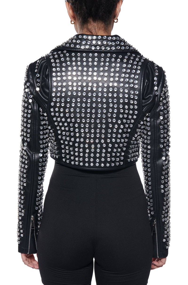 back view of black cropped faux leather moto jacket embellished with silver rhinestone gems all over