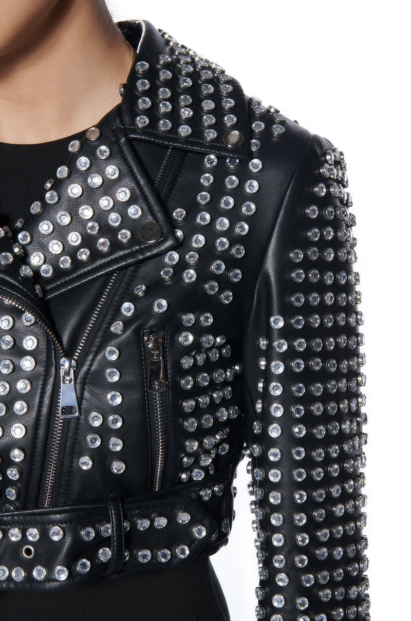 detail shot of black cropped faux leather moto jacket embellished with silver rhinestone gems all over