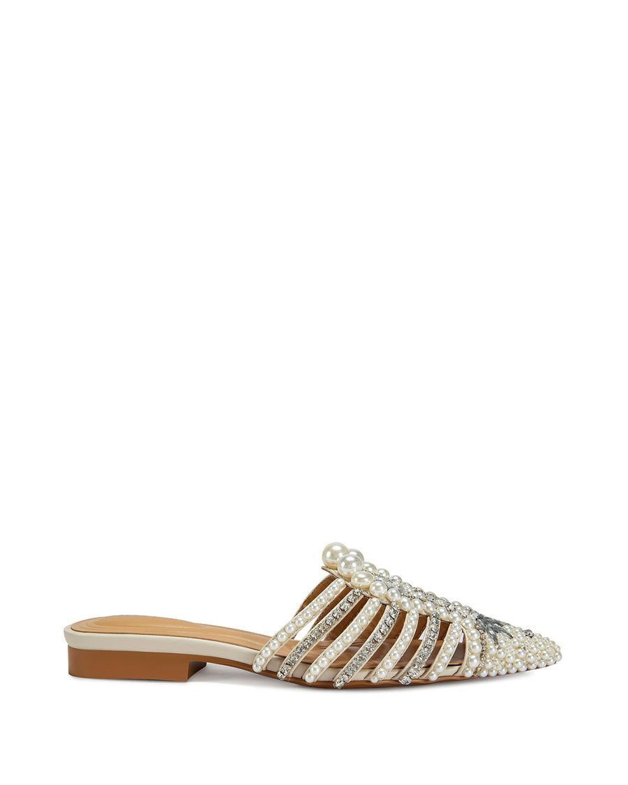 side view of sparkly pointed toe slip on flat sandals with a caged upper lined with faux pearl and rhinestone embellishments