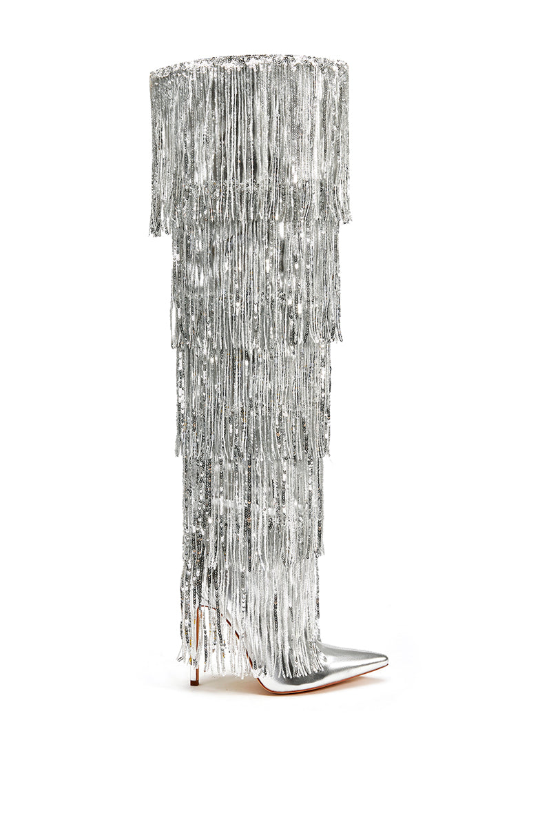 side view of silver knee high boots with layers of shiny metallic silver fringe detail on the shaft