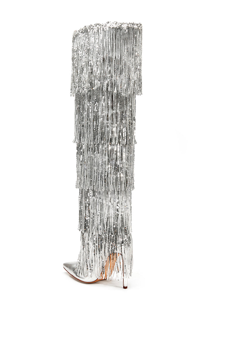 back view of  silver knee high boots with layers of shiny metallic silver fringe detail on the shaft