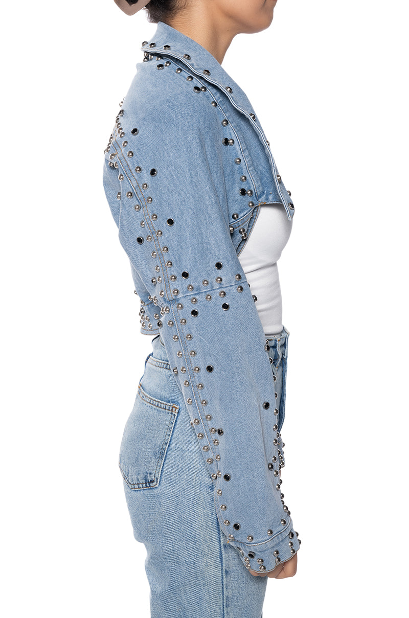 side view of light wash denim ultra cropped jacket with circular stud accents lining the seams