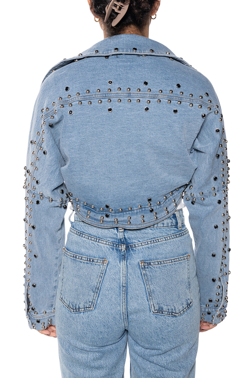 back view of light wash denim ultra cropped jacket with circular stud accents lining the seams