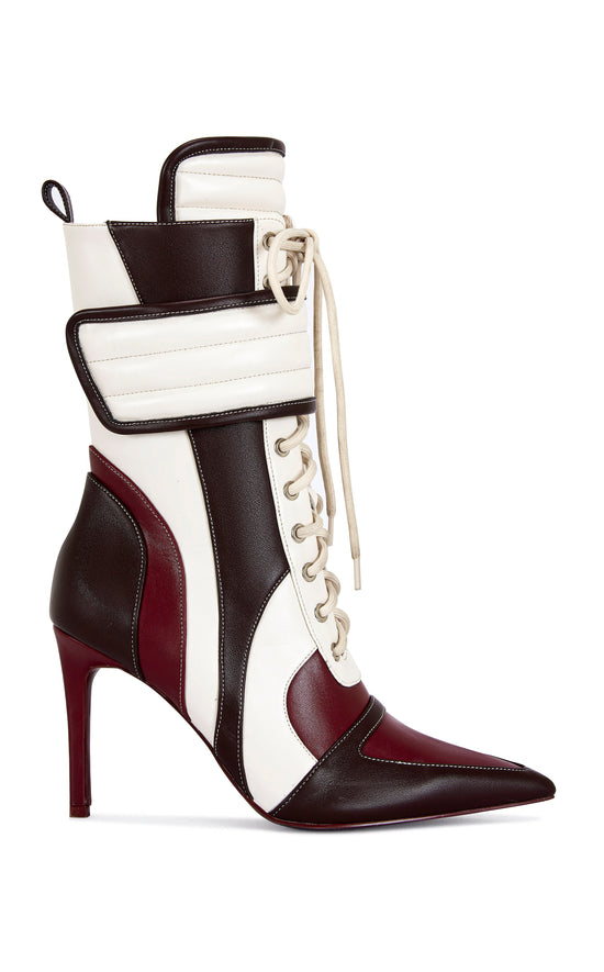 burgundy, brown, and white faux leather heeled boots with a mid calf length, lace up accent, and velcro belted accent with an inner zip up closure