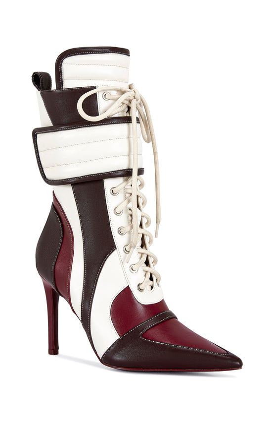 burgundy, brown, and white faux leather heeled boots with a mid calf length, lace up accent, and velcro belted accent with an inner zip up closure