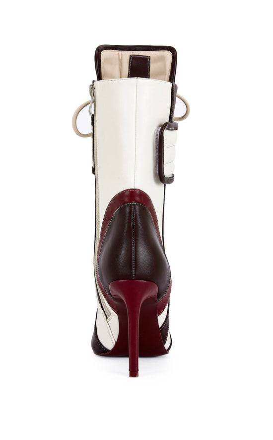 burgundy, brown, and white faux leather heeled boots with a mid calf length, lace up accent, and velcro belted accent with an inner zip up closure
