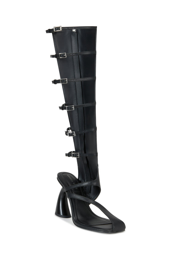 black faux leather statement heels with a curved block heel, experimental open toe style, and a knee high length shaft with open belted cutouts  on the outer shaft. 