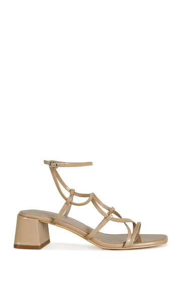 beige faux leather strappy sandals with a square block heel and an adjustable ankle strap
