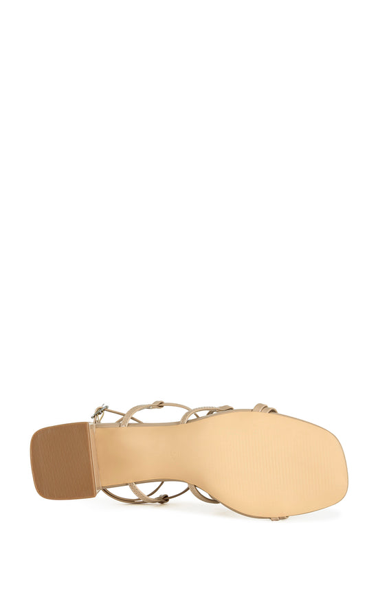 beige faux leather strappy sandals with a square block heel and an adjustable ankle strap