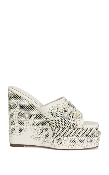 statement faux leather platform open toe wedge heels with western inspired  fire patterns and silver studs on the sides.