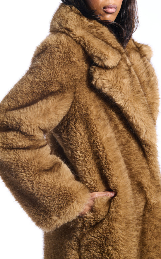 light brown faux fur statement trench coat with an oversized collar and pockets on the front sides