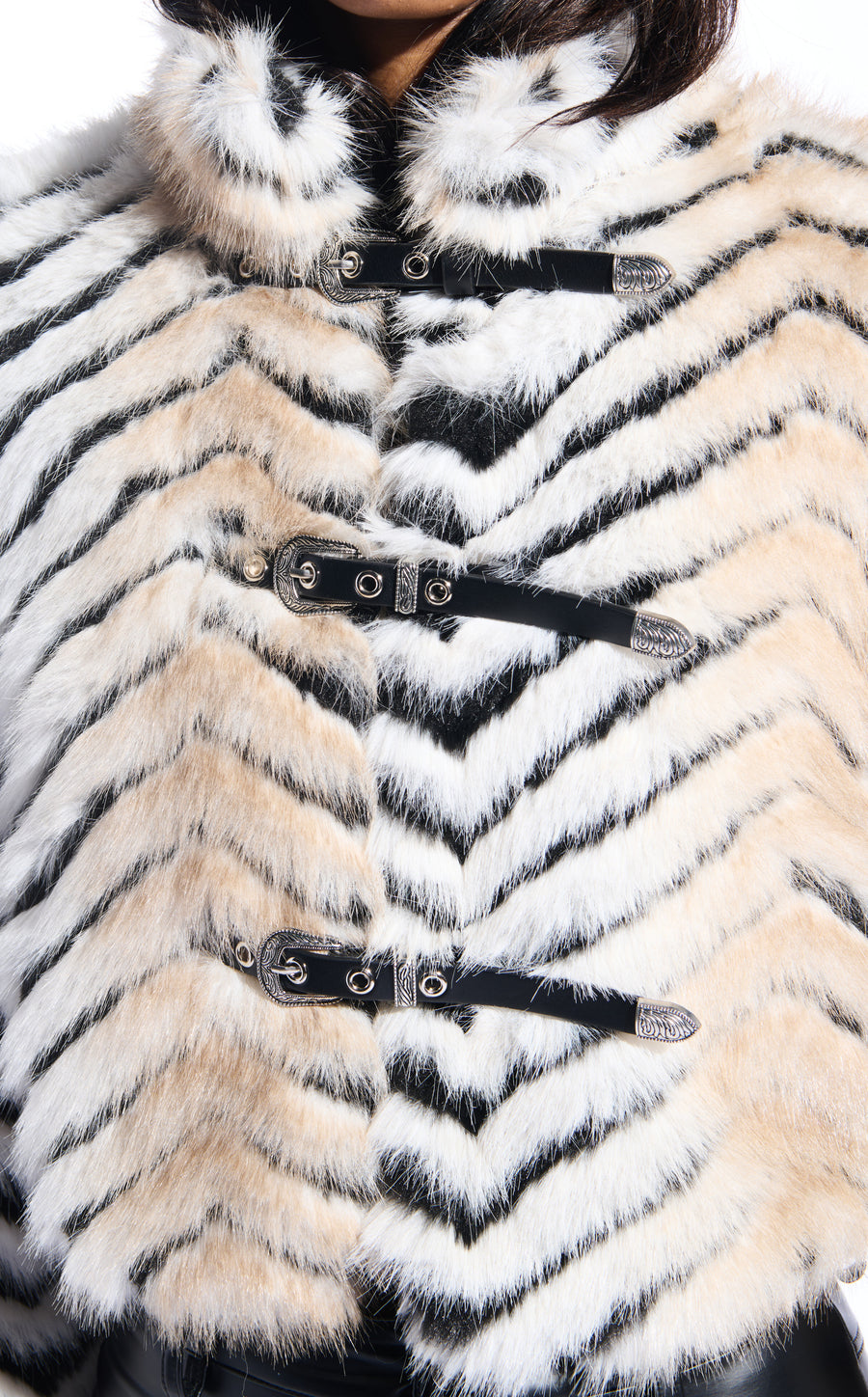 black and beige stripe print faux fur statement coat with a cropped silhouette and adjustable western inspired belt closure accents