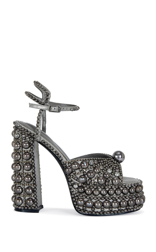 platform heeled peep toe statement heels with hematite pearl embellishments all over the heel, finished with an adjustable ankle strap
