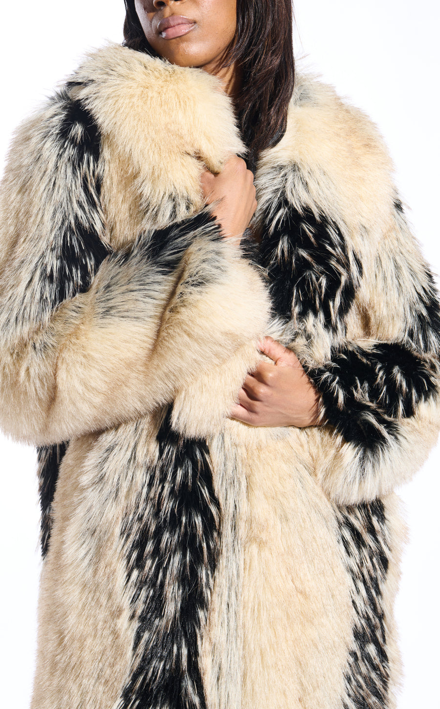 beige and black patterned faux fur statement trench coat wit an oversized collar and pockets