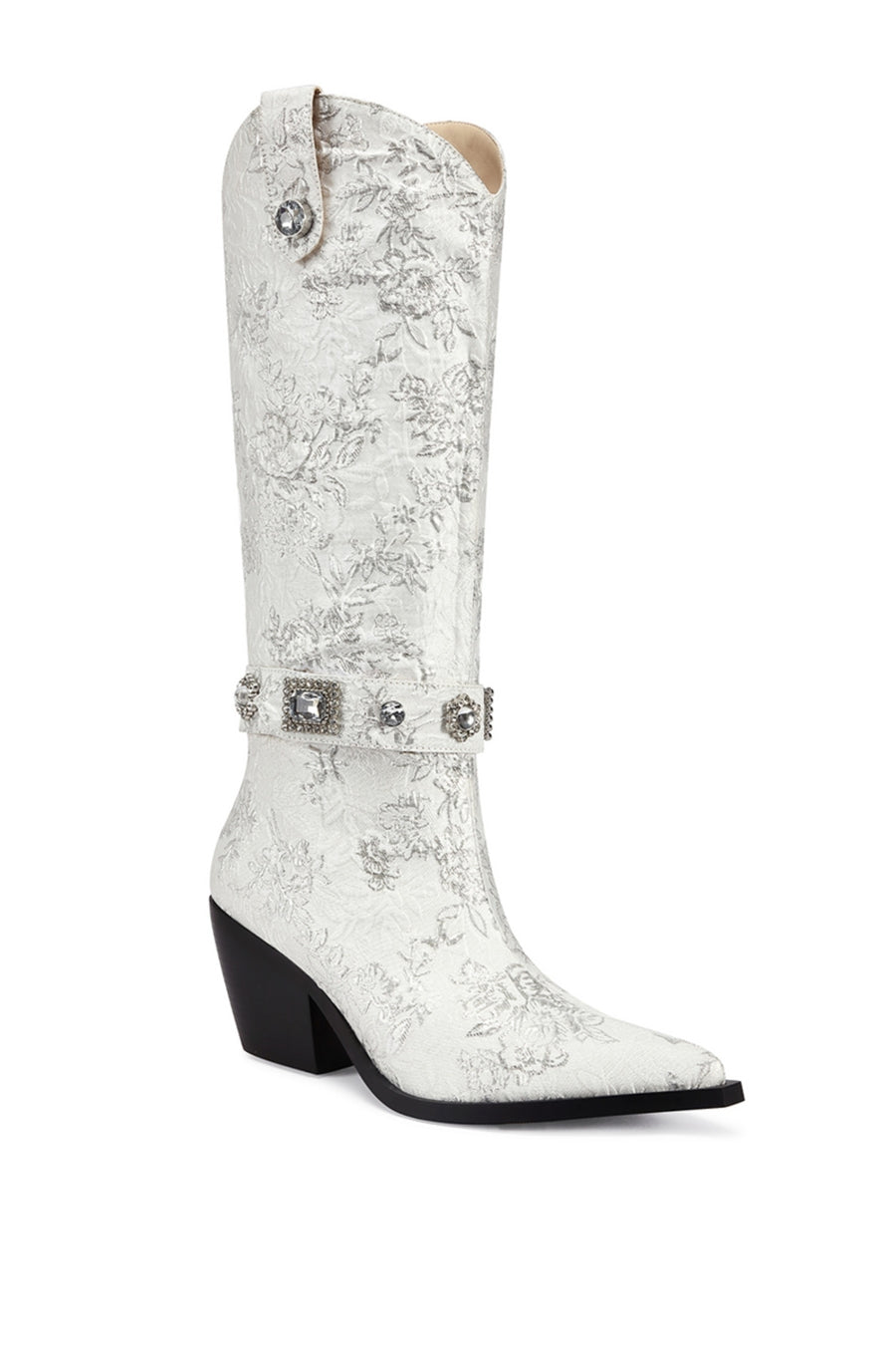 angled view of white satin floral print statement western boot with crystal embellished belted accents and a black block heel