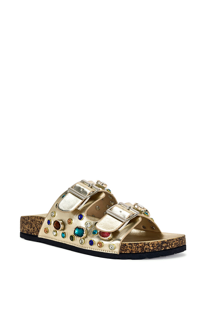 angled view of open toe flat sandal with double straps, metallic gold fabrication, and multicolored gemstone embellishments