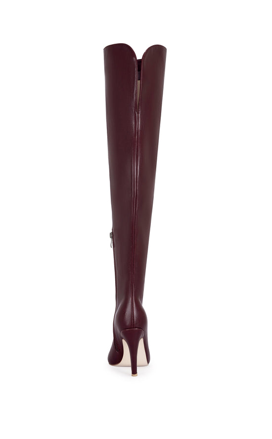 burgundy faux leather thigh high boots with a stiletto heel and pointed toe silhouette