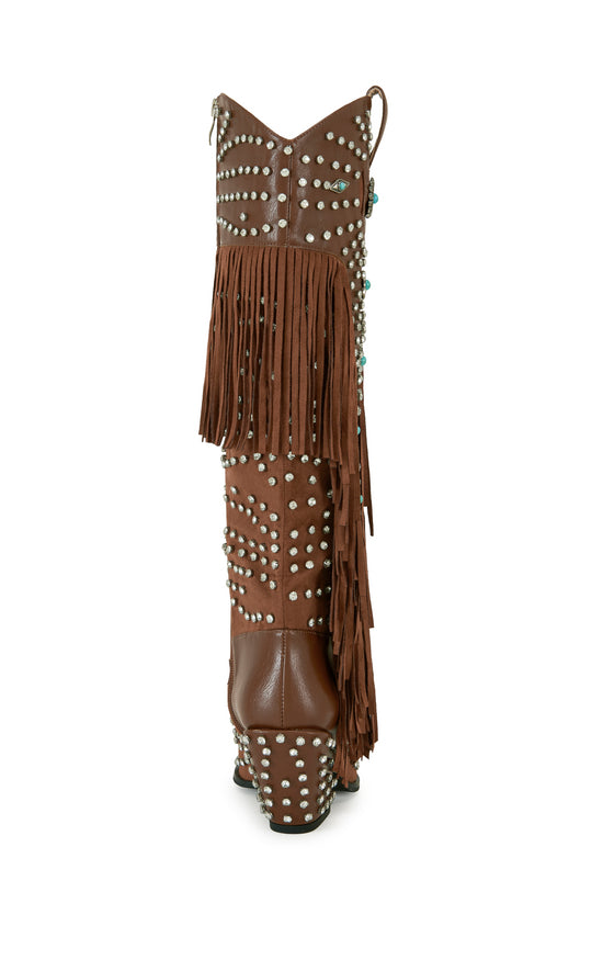 Brown faux leather statement western knee high boots with faux swede fringe, rhinestone embellishments, and turquoise flower accents on the shaft
