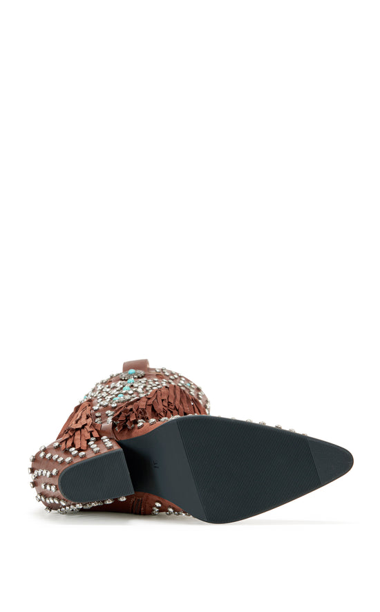 Brown faux leather statement western knee high boots with faux swede fringe, rhinestone embellishments, and turquoise flower accents on the shaft