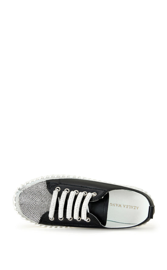 black faux leather statement sneakers with a white platform sole and a crystal embellished toe and side of the sole