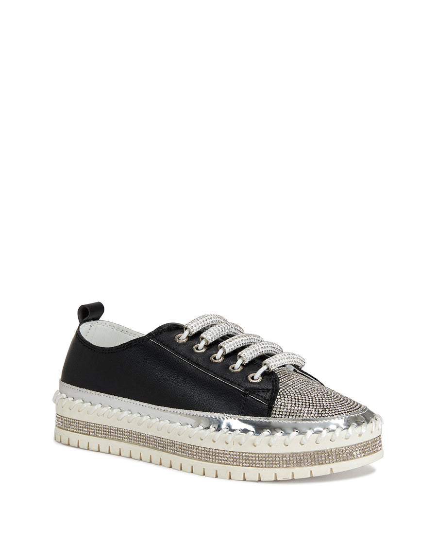 angled view of black faux leather statement sneakers with a white platform sole and a crystal embellished toe and side of the sole