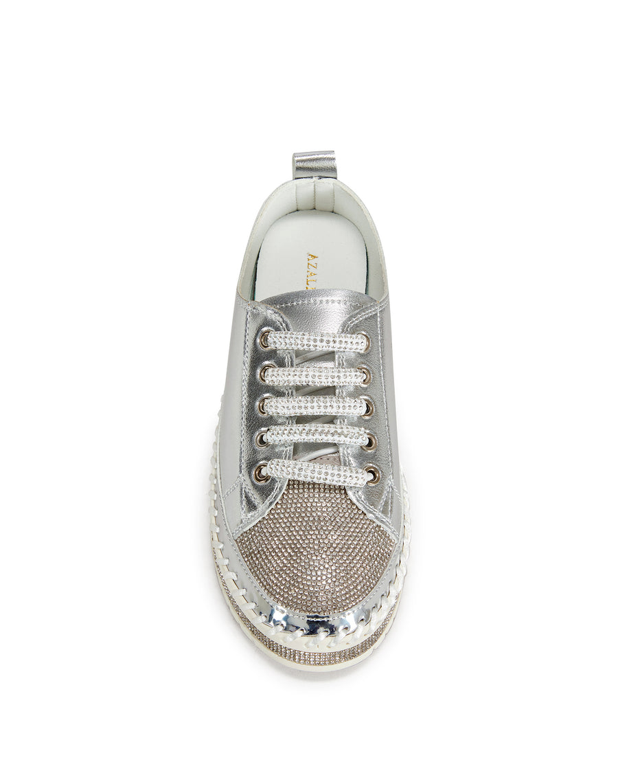 top view of metallic silver faux leather statement sneakers with a white platform sole and a crystal embellished toe and side of the sole