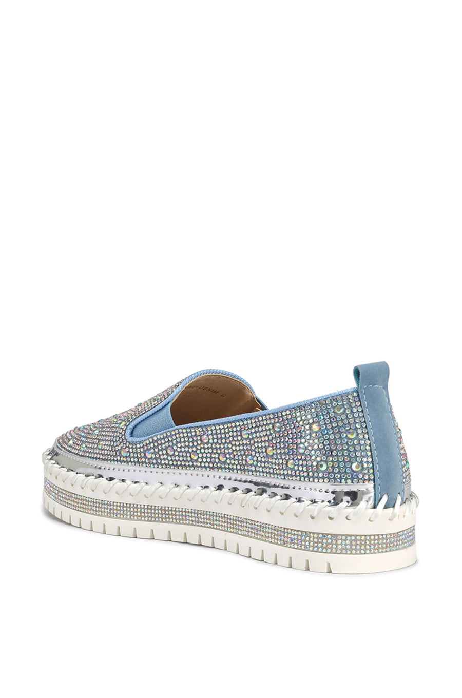 back view of slip on light wash denim flat sneakers with crystal rhinestone embellishments and a white braided platform sole