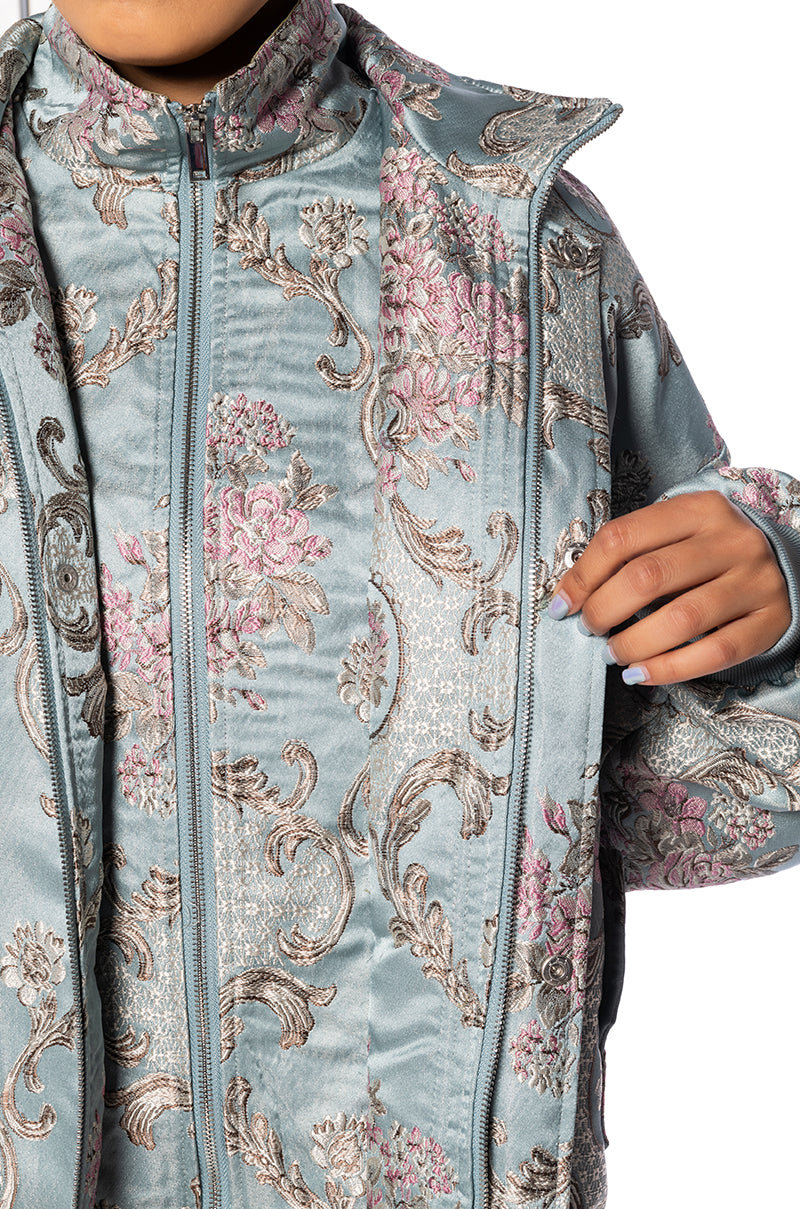 detail shot of satin blue brocade patterned statement bomber jacket