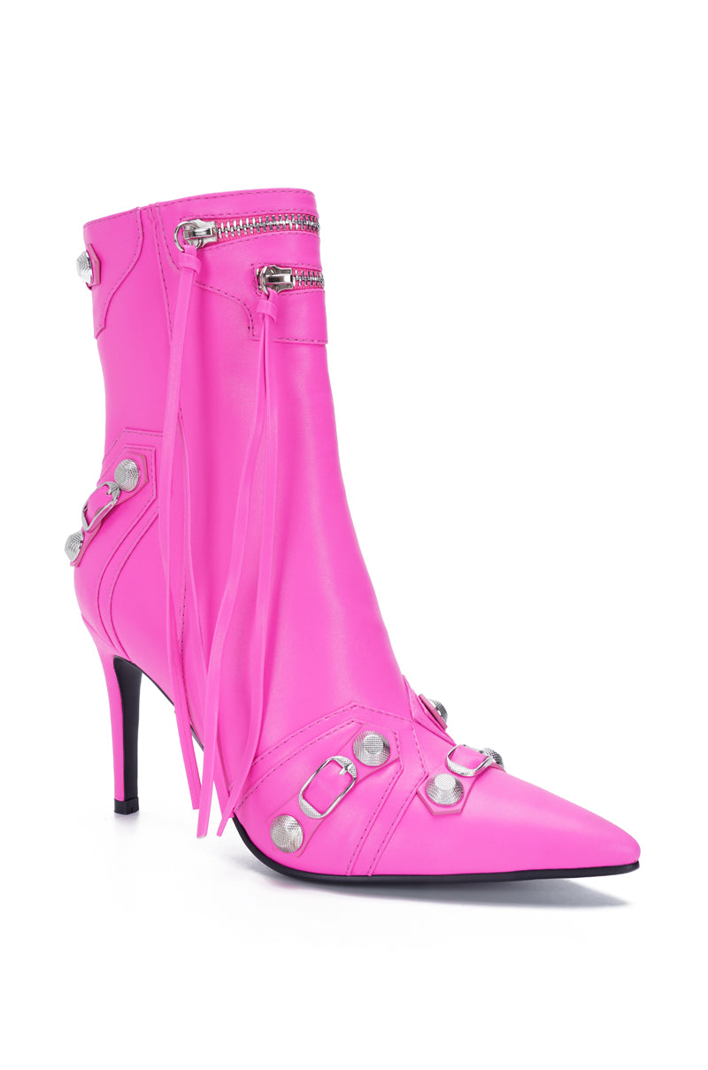 angled view of hot pink pointed toe stiletto ankle booties made of faux leather and zipper details with silver hardware accents