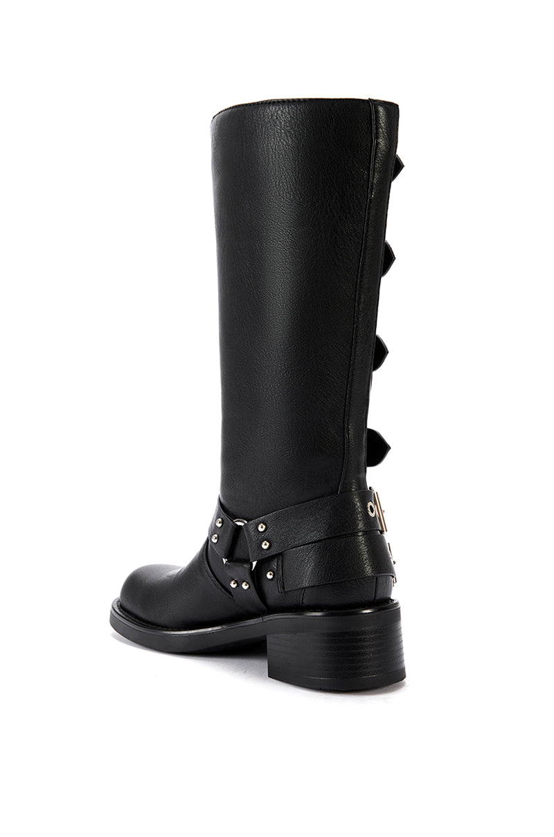 back view of  mid calf length black faux leather boots with a rounded toe, small block heel, and silver buckle design going up the shoe