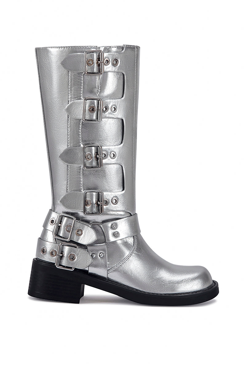 side view of mid calf length metallic silver faux leather boots with a rounded toe, small block heel, and silver buckle design going up the shoe