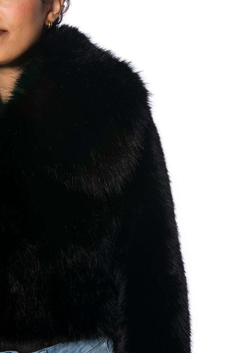 detail shot of luxurious black faux fur cropped jacket
