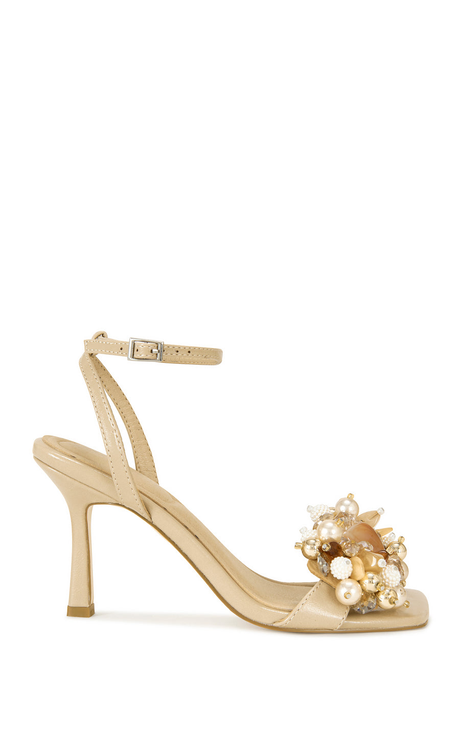 beige faux leather open toe statement sandals with a stiletto heel, adjustable ankle strap, and faux pearl and seashell embellished foot strap