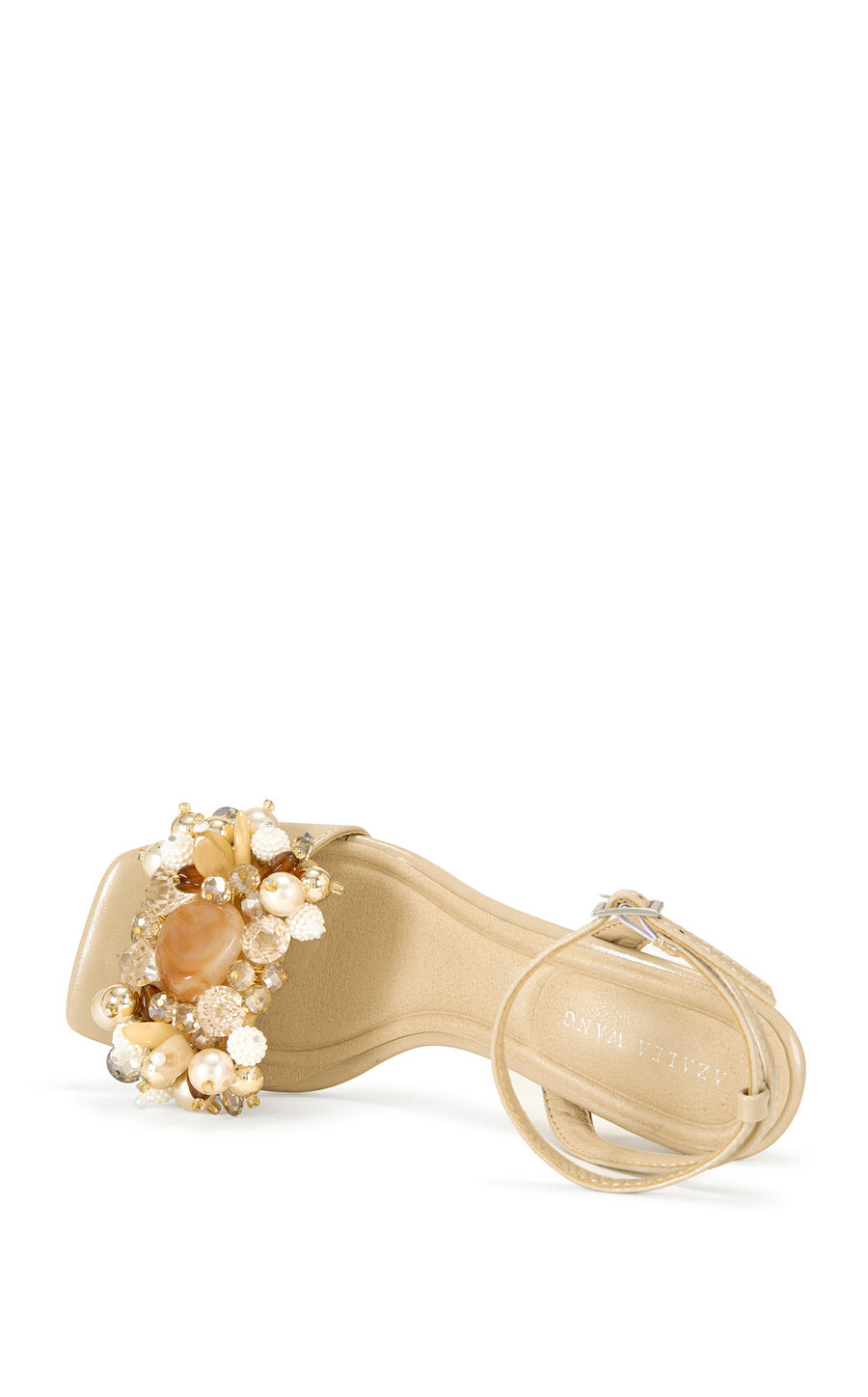 beige faux leather open toe statement sandals with a stiletto heel, adjustable ankle strap, and faux pearl and seashell embellished foot strap