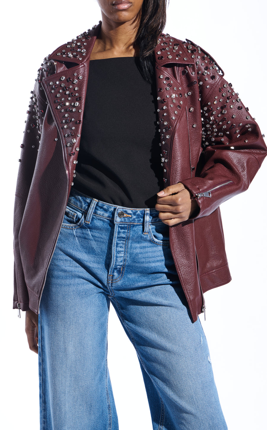burgundy faux leather statement coat with  an oversized fit, zips on the sleeves, and sparkly rhinestone embellishments on the collar and sleeves