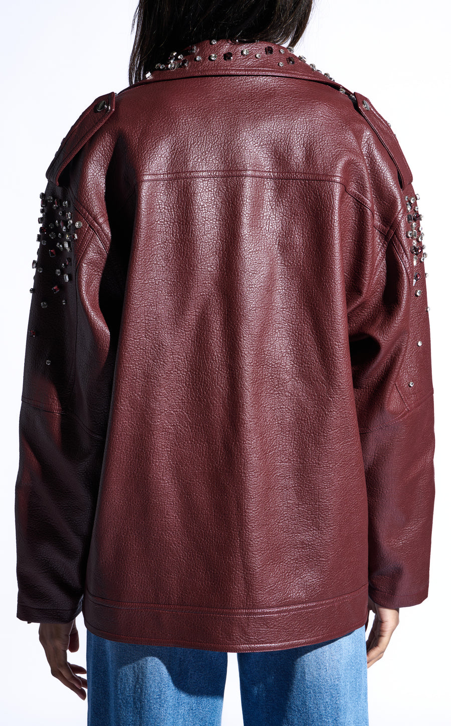 burgundy faux leather statement coat with  an oversized fit, zips on the sleeves, and sparkly rhinestone embellishments on the collar and sleeves