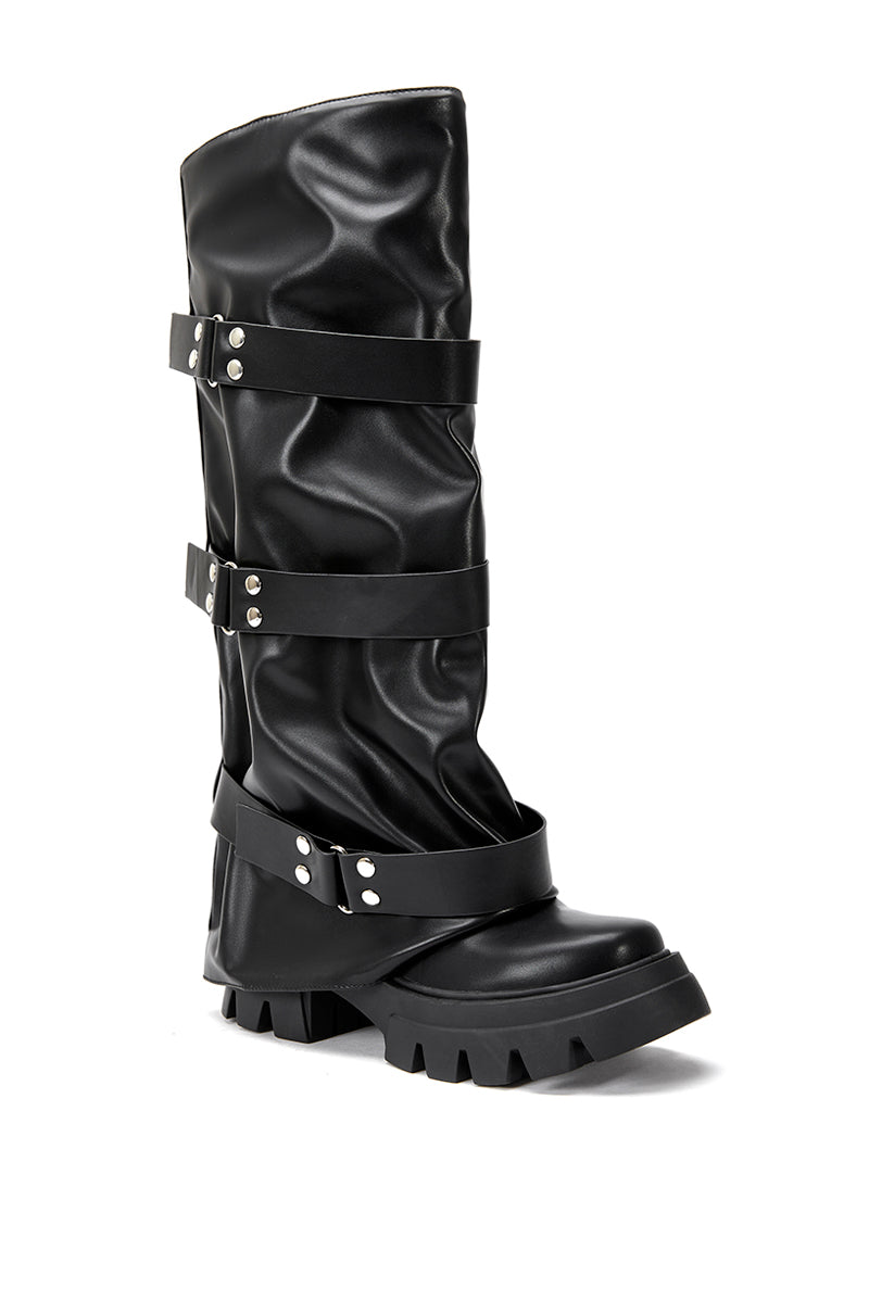 side view of platform knee high fold over black faux leather boots with three accent straps on shaft