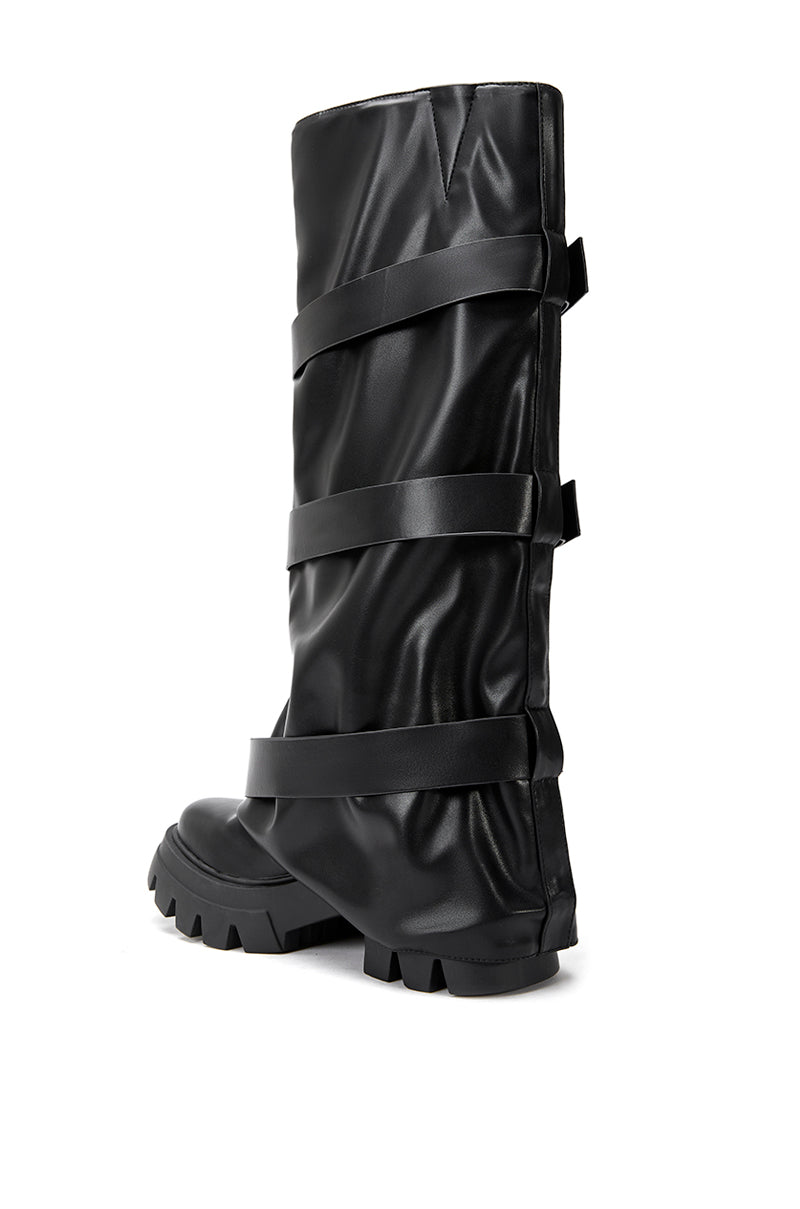 back view of platform knee high fold over black faux leather boots with three accent straps on shaft
