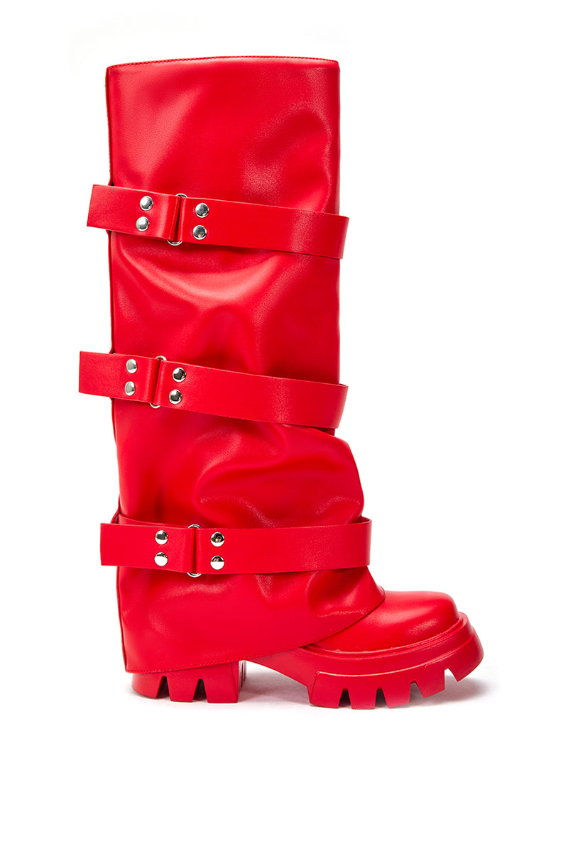 side view of cherry red platform knee high fold over black faux leather boots with three accent straps on shaft