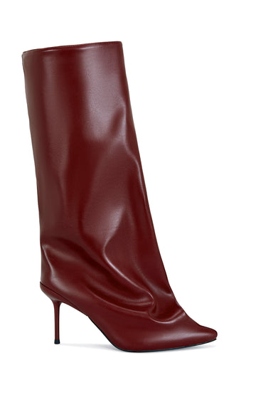 wine red faux leather knee high boot with a pointed toe, stiletto heel, and a slouched shaft