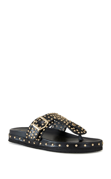 black faux leather slip on flat sandal with a thong strap and gold stud embellishments, finished with a gold belted accent on the upper