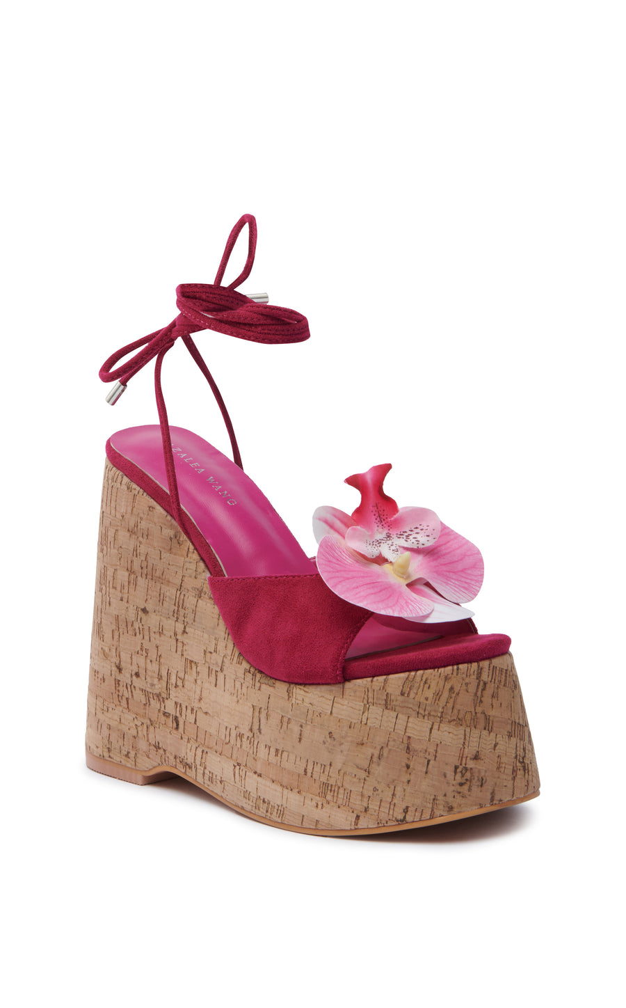 ultra platform heeled wedge sandals with an open toe and fuchsia faux suede upper with an orchid flower accent on the foot strap and two faux suede wrap cords