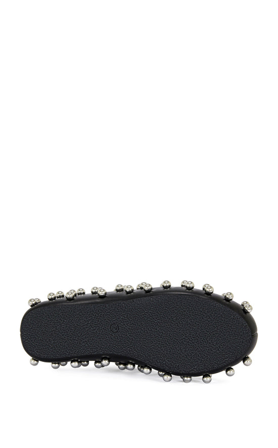 black faux leather statement mule with a sip on fit and circular stud embellishments on the upper