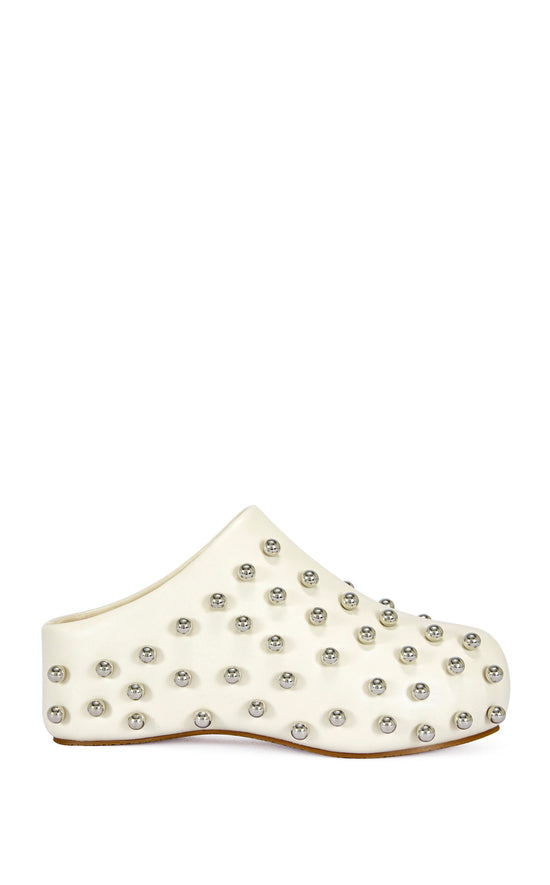 cream faux leather statement mule with a sip on fit and circular stud embellishments on the upper