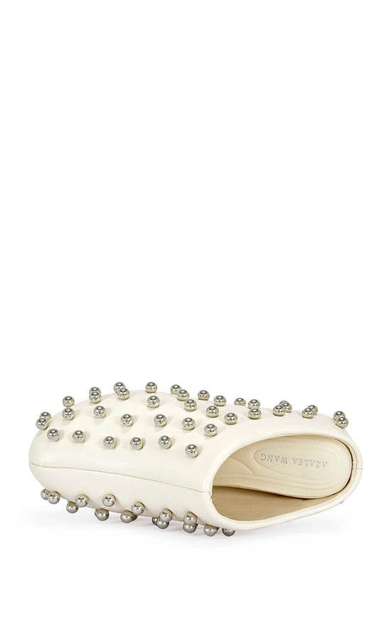 cream faux leather statement mule with a sip on fit and circular stud embellishments on the upper