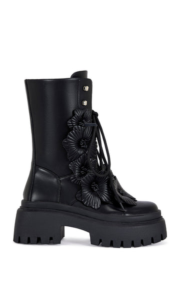 black faux leather mid calf length combat bootie with a chunky platform sole and  black faux leather flower embellishments on the shaft