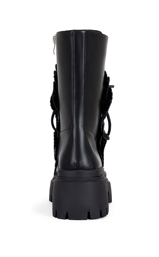 black faux leather mid calf length combat bootie with a chunky platform sole and  black faux leather flower embellishments on the shaft