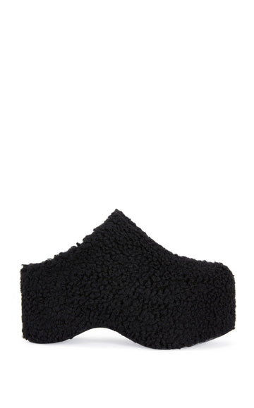 black faux sherpa slip on mule with a  curved platform sole